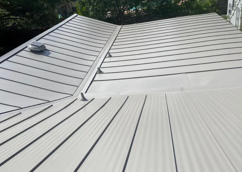 Solar attic fan installed on a metal roof for Roof Ventilation in Atlas